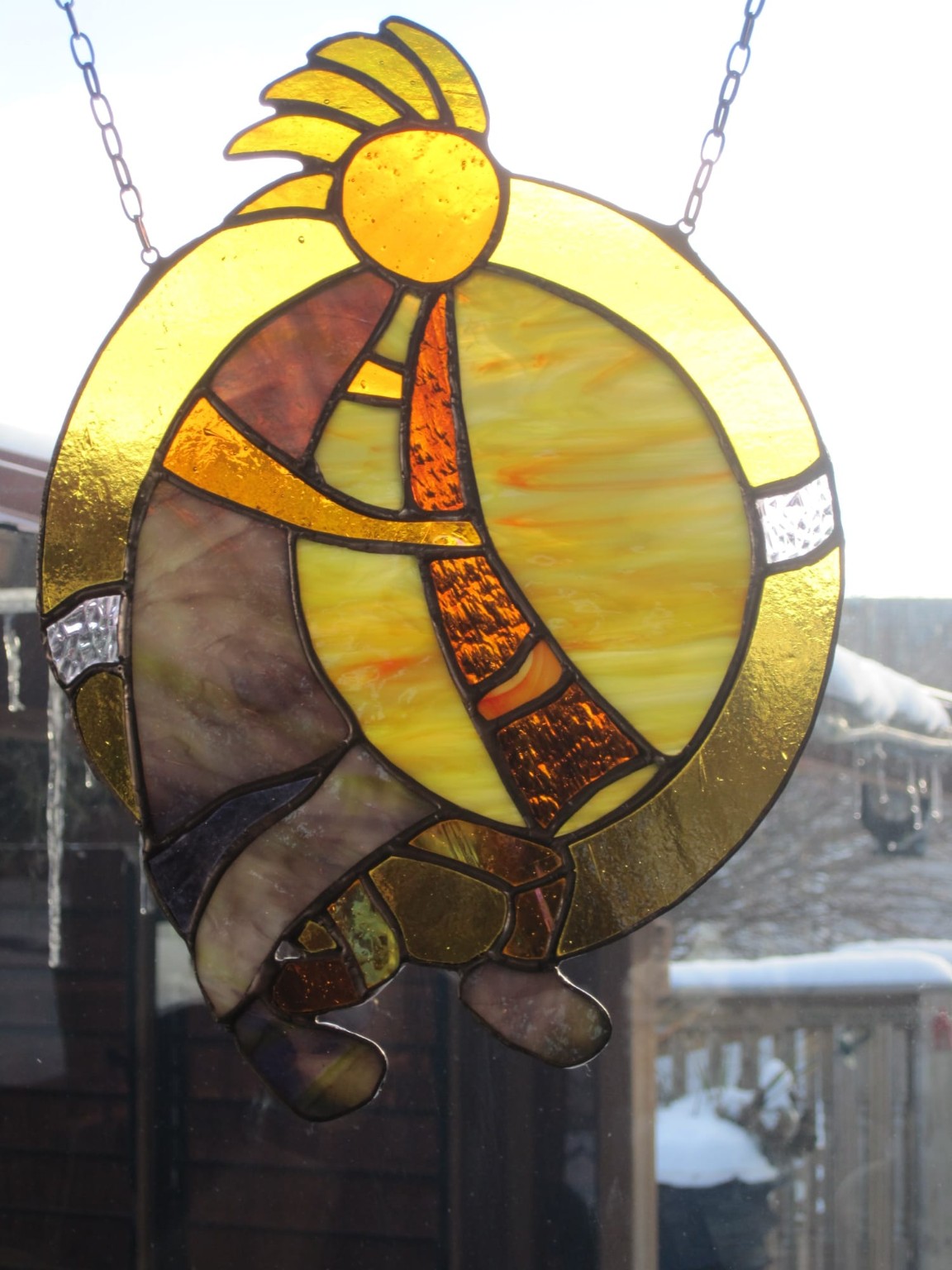 Circular golden stained-glass hanging created by one of Paul's students